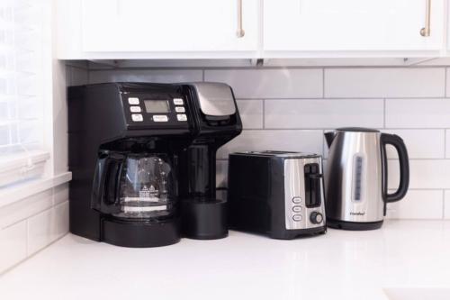 a black coffee maker sitting on a kitchen counter at 3 BDR Renovated Condo The Beach1 block in Wildwood
