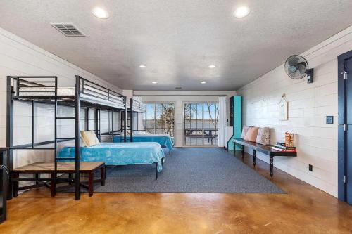 a bedroom with a blue bed and bunk beds at Gilead Grand Lake Family Retreat in Grove