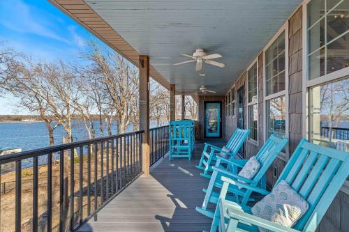 a porch with blue chairs on a house at Gilead Grand Lake Family Retreat in Grove
