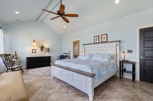 a bedroom with a bed and a ceiling fan at Gilead Grand Lake Family Retreat in Grove