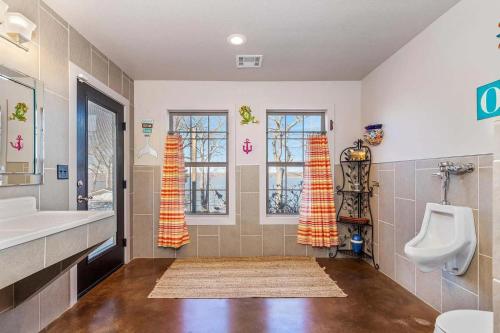 a bathroom with a urinal and a sink and a toilet at Gilead Grand Lake Family Retreat in Grove