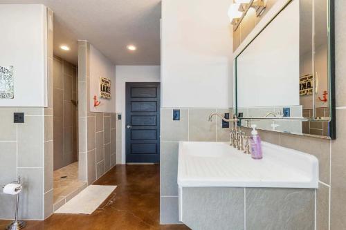 a bathroom with a sink and a blue door at Gilead Grand Lake Family Retreat in Grove