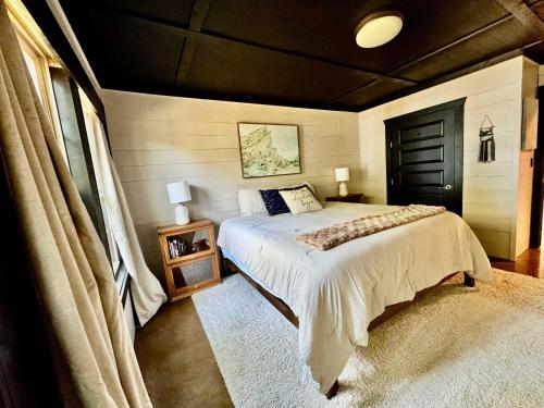 a bedroom with a bed and a black door at Gilead Grand Lake Family Retreat in Grove