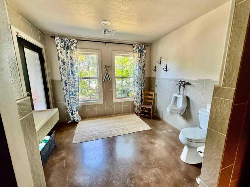 a bathroom with a toilet and a window at Gilead Grand Lake Family Retreat in Grove