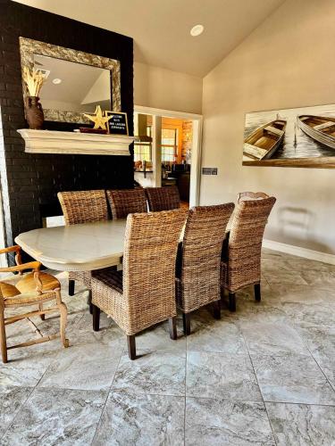 a dining room with a table and wicker chairs at Gilead Grand Lake Family Retreat in Grove