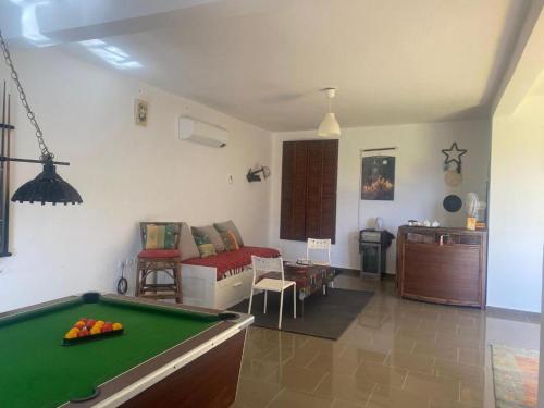 a living room with a pool table and a couch at Le Petit Yucca in Tiznit