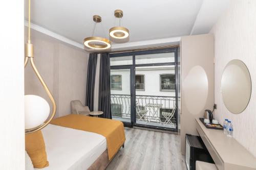 a hotel room with a bed and a balcony at Massimo Hotel in Istanbul