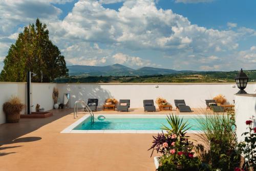 a villa with a swimming pool and mountains in the background at House Milovanovic in Soko Banja