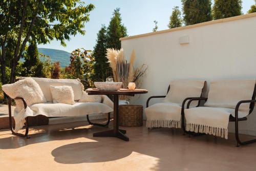two chairs and a table on a patio at House Milovanovic in Soko Banja
