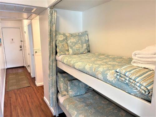 a couple of bunk beds in a room at Breakers 221 - Walk To Beach, Shops And Dining in Hilton Head Island