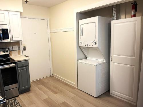 a kitchen with a white refrigerator and a microwave at Fiddler's Cove 11e - Updated Folly Field Villa in Hilton Head Island
