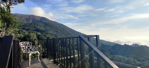 a chair sitting on a balcony with a view of a mountain at Bosques del Tibet in Cerro Verde