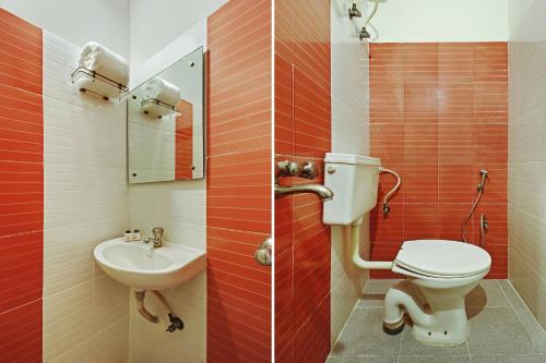 a bathroom with a toilet and a sink at Super Hotel O Golden Hive Madhapur Near Shilparamam in Hyderabad