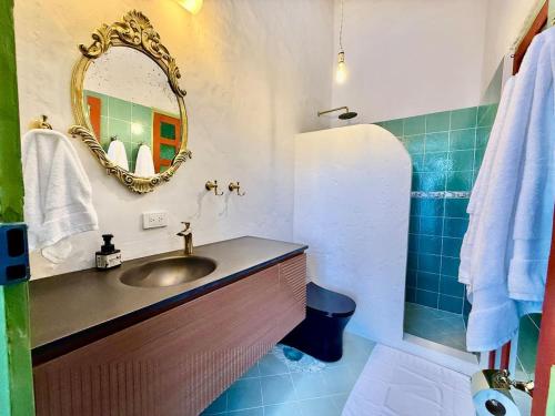 a bathroom with a sink and a mirror at Elegant Colonial Walkable Casa in Jericó