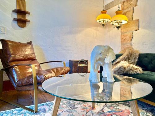 a glass table with a toy elephant on top of it at Elegant Colonial Walkable Casa in Jericó