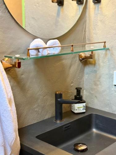 a bathroom sink with a faucet and a mirror at Elegant Colonial Walkable Casa in Jericó