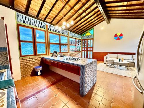 a kitchen with a stove in a room with windows at Elegant Colonial Walkable Casa in Jericó