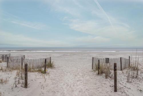 an empty beach with a fence in the sand at Seascapes 3061 - Roomy Villa Close To Beach in Hilton Head Island