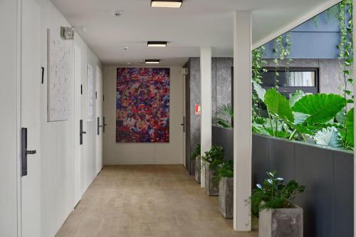 a hallway of an office with a tapestry on the wall at Casa Guogu by AmazINN Places 3f in Panama City