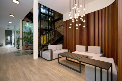 a lobby with a table and chairs and a chandelier at Casa Guogu by AmazINN Places 3f in Panama City