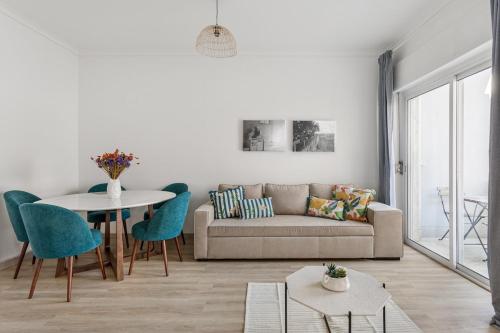 a living room with a couch and a table at GuestReady - Striking flat in Benfica in Lisbon