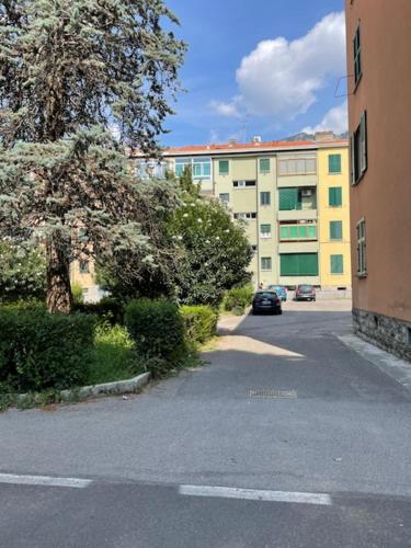 a street with a building and a car on the road at Il Mughetto in Lecco