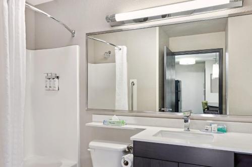 a bathroom with a sink and a mirror at Candlewood Suites Appleton by IHG in Appleton