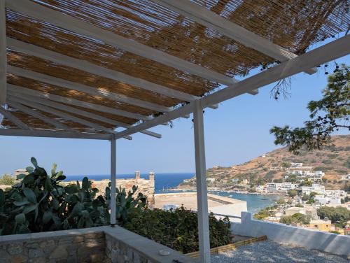 a view of the ocean from a house with a pergola at Agreli in Kinion