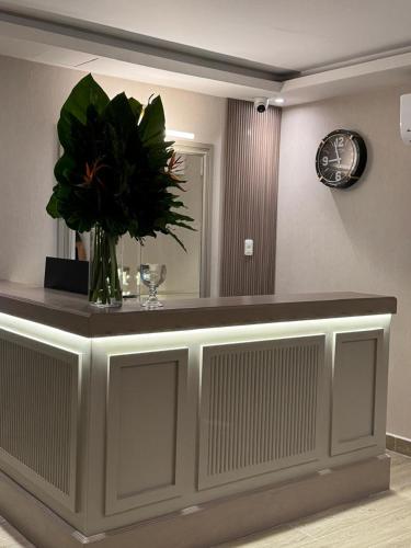 a vase of flowers on a counter in a room at Caonabo35 Santo Domingo 208 in Santo Domingo