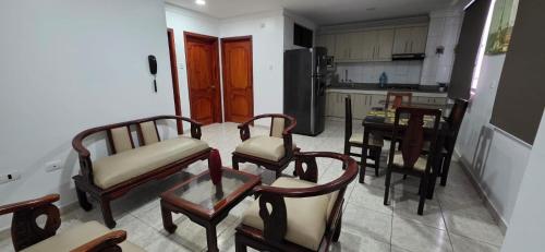 a kitchen with chairs and a table in a kitchen at Departamento Manta in Manta