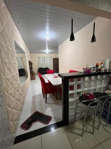 a kitchen and dining room with a table and chairs at Casa in Ananindeua