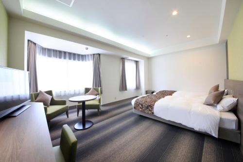 En eller flere senger på et rom på Hotel Sunshine Utsunomiya