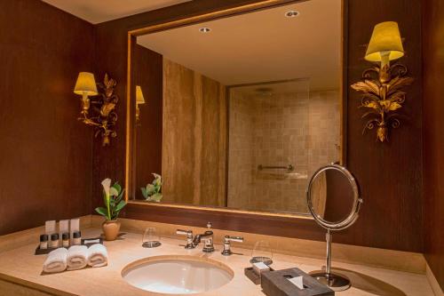 a bathroom with a sink and a large mirror at Palacio del Inka, a Luxury Collection Hotel, Cusco in Cusco