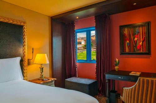 a bedroom with a bed and a window at Palacio del Inka, a Luxury Collection Hotel, Cusco in Cusco