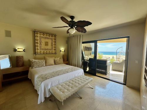 a bedroom with a bed and a ceiling fan at Unit 135 - Beachfront Heaven Ocean Front at Terrasol in Cabo San Lucas