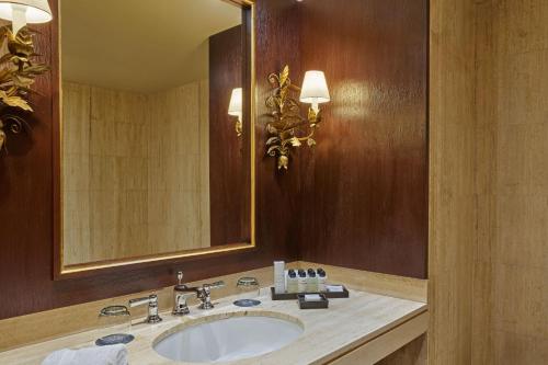 a bathroom with a sink and a large mirror at Palacio del Inka, a Luxury Collection Hotel, Cusco in Cusco
