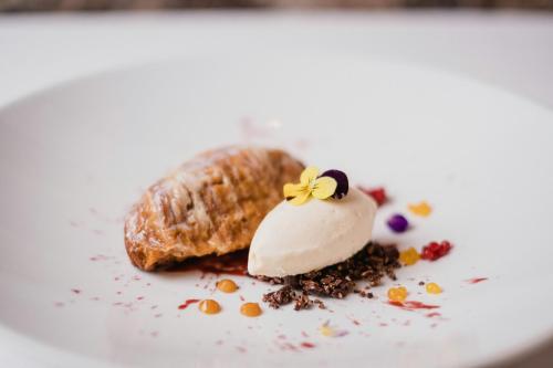a dessert on a white plate with a pastry at Palacio del Inka, a Luxury Collection Hotel, Cusco in Cusco
