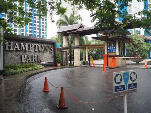 a parking lot with orange cones in front of a building at Spacious living room Hampton's Park Apartment in Jakarta