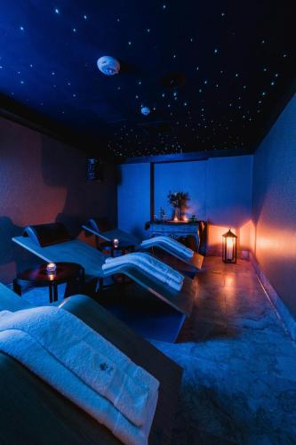 a room with three beds and a room with planets on the ceiling at Palacio del Inka, a Luxury Collection Hotel, Cusco in Cusco