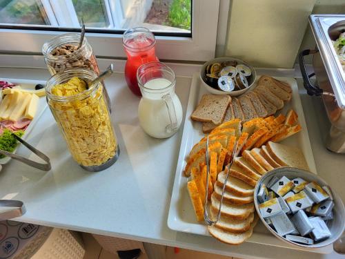 a table with sandwiches and other food items on it at Kama Retreat in Kerpenyest