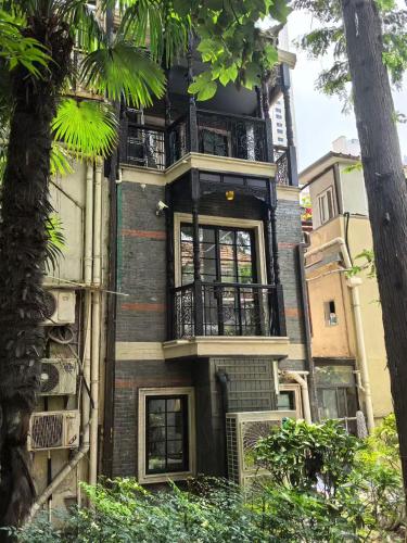 an apartment building with a balcony on the side of it at A detached, old Shanghai villa on Huaihai Middle Road in Shanghai