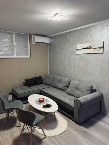 a living room with a couch and a table at Apartman Đak in Foča