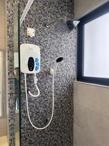 a shower with a shower head in a bathroom at Coco homes Seaview 4 pax at The Shore A0712 in Kota Kinabalu