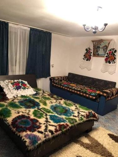 a bedroom with two beds and a rug at Pensiunea Brezu in Sighetu Marmaţiei