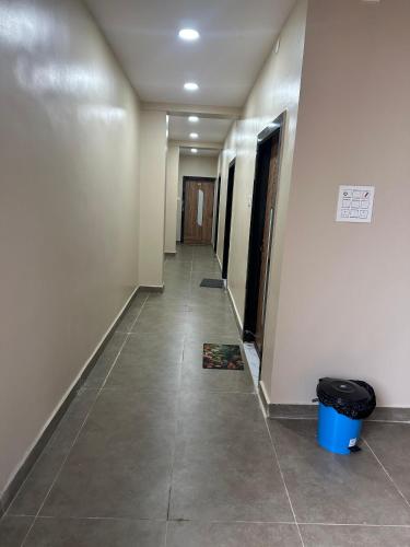 an empty hallway with a trash can on the floor at KML Grand Stay in Bhadrāchalam