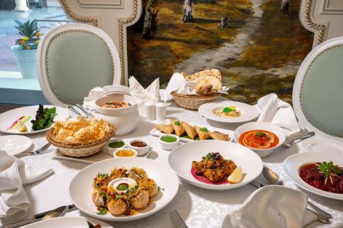a table with plates of food on it at Sunset Jeddah in Jeddah