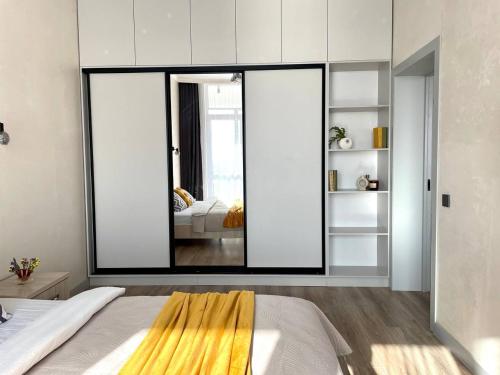 a bedroom with a large mirror and a bed at Уютные Апартаменты 1 Минута от Станции Метро in Almaty