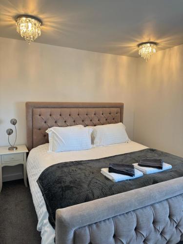 a bedroom with a large bed with two towels on it at Amazing City Centre Home in Derby
