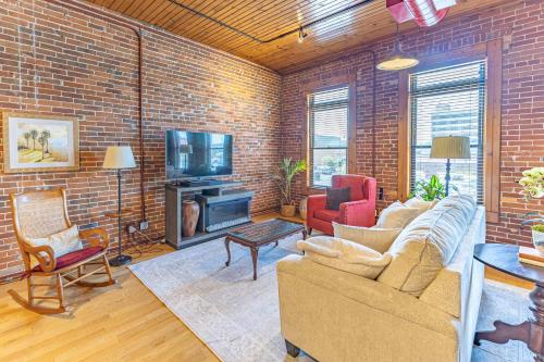a living room with a brick wall at Gorgeous apartment across from La Crosse Center in La Crosse