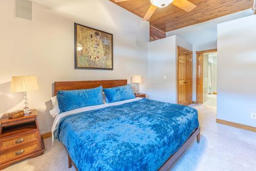 a bedroom with a large blue bed with a wooden headboard at Gorgeous apartment across from La Crosse Center in La Crosse
